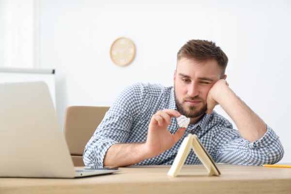 como aumentar a produtividade no trabalho homem com preguiça jogando papel