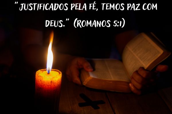 versículos com fé bíblia aberta e vela acesa no escuro