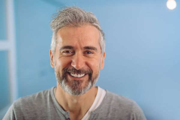 como conquistar homens mais velhos homem de cabelo grisalho sorrindo com barba e bigode